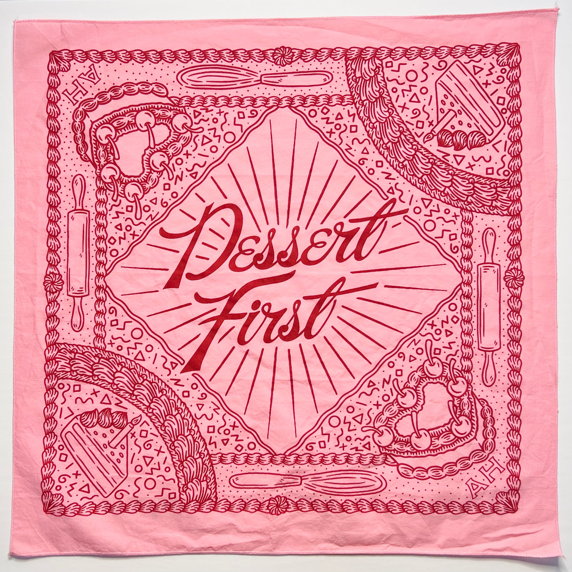 pink fabric bandana with maroon ink
